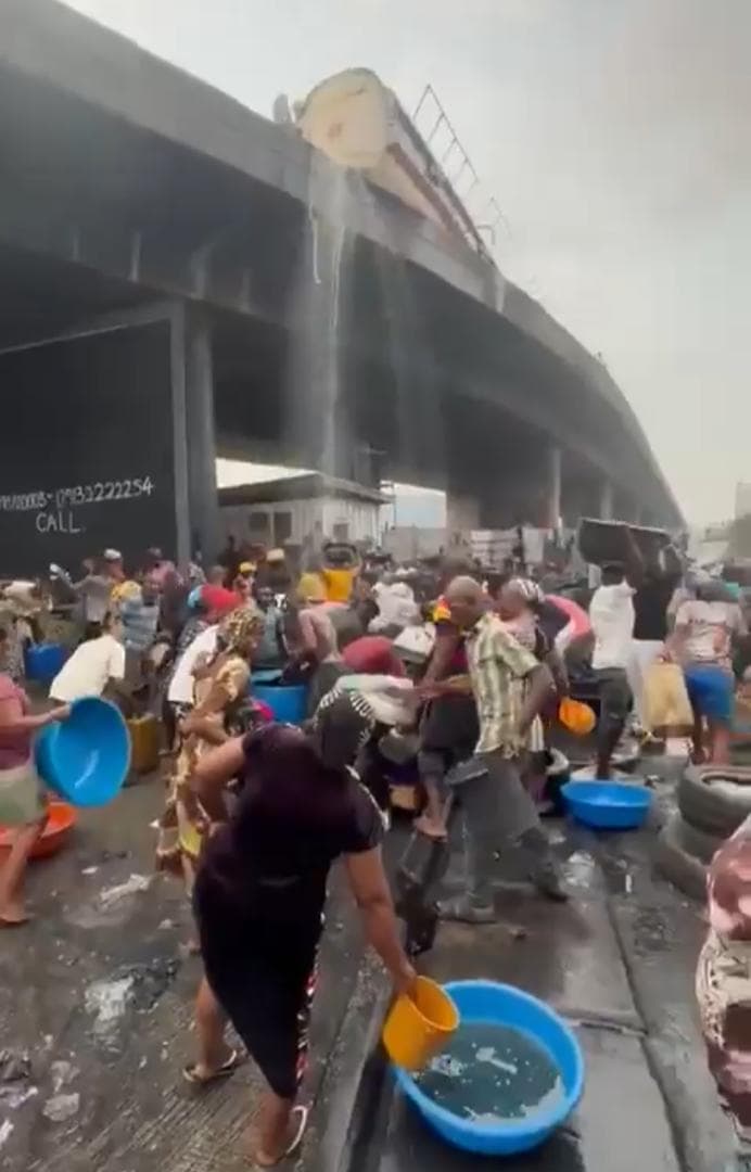 Fuel Tanker Overturns at Apapa Bridge, Residents Rush to Scoop PMS
